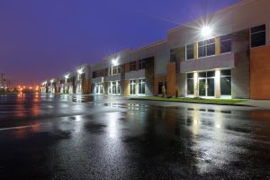 exterior of an industrial park building with the lights on