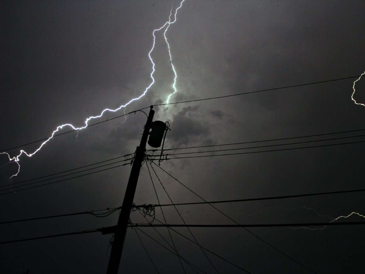 lightening strike at night by powerline
