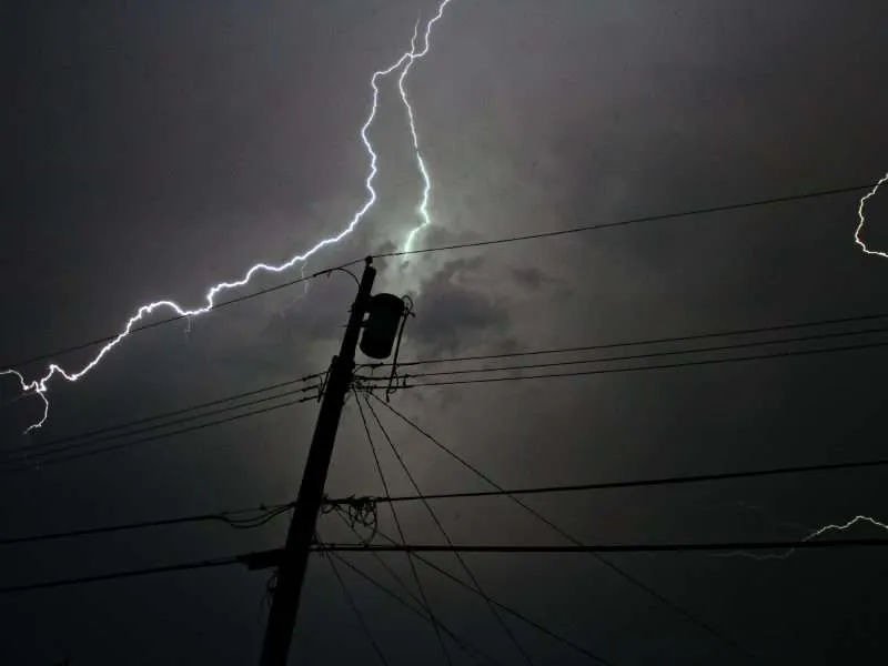 lightening strike at night by powerline