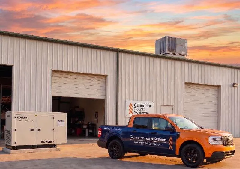 Picture of Generator Power Systems truck in front of a shop building.